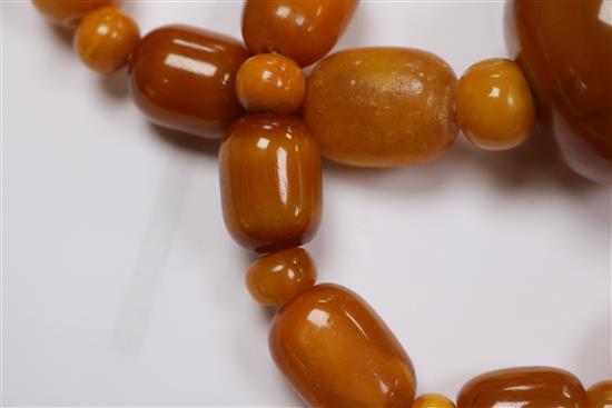 A part amber bead necklace and a pair of amber bead earrings.
